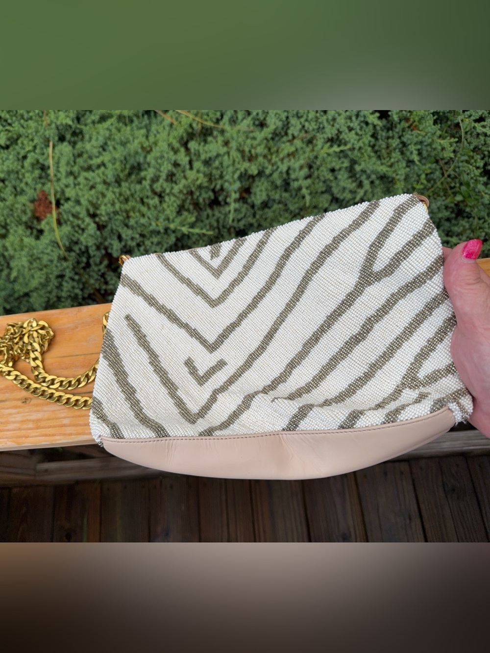 Sseko beaded zebra clutch featuring a hand-beaded removable gold chain strap
